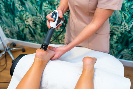 Woman receiving modern therapy to reduce pain | ProFysio Physical Therapy