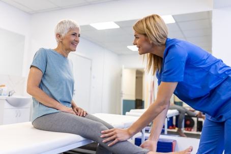 Woman with a physical therapist working on range of motion exercises after surgery..