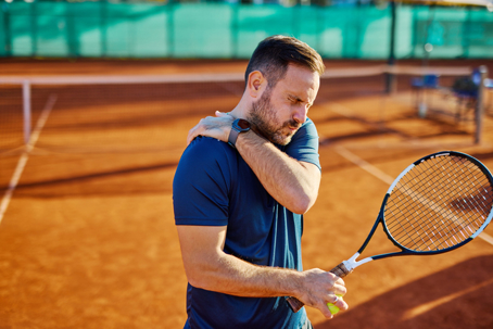 Athlete with shoulder pain during tennis match