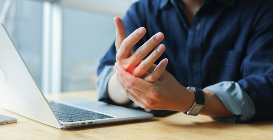 Hand pain and finger stiffness from repetitive strain while working on laptop